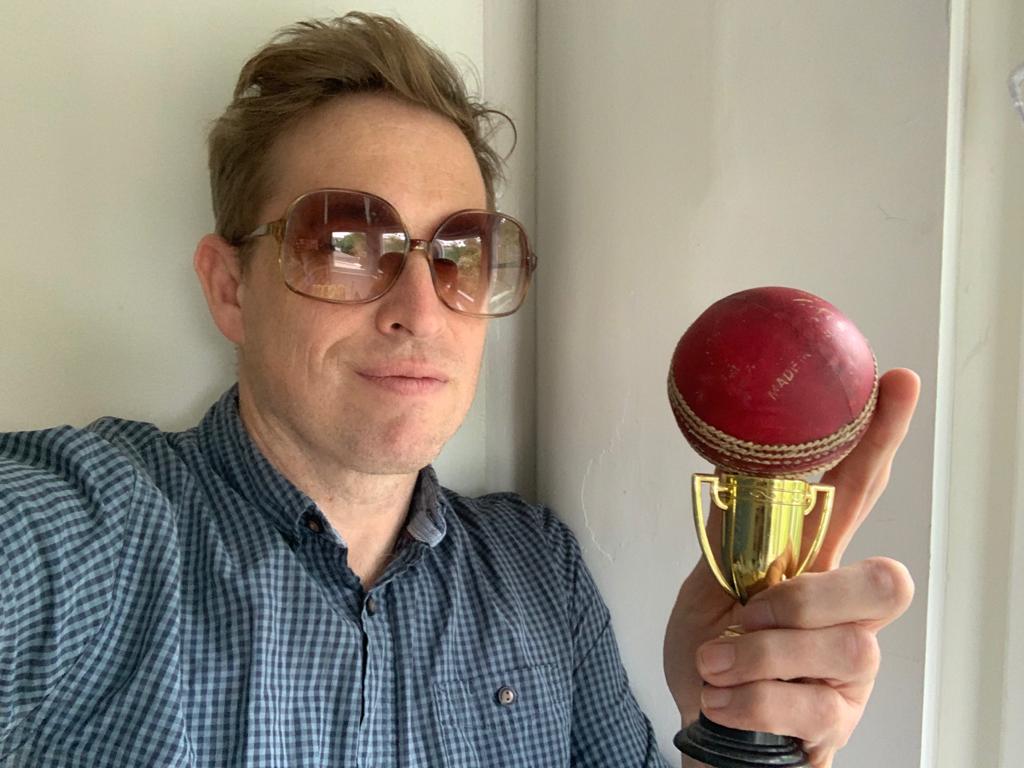 A person holding a trophy
Description automatically generated