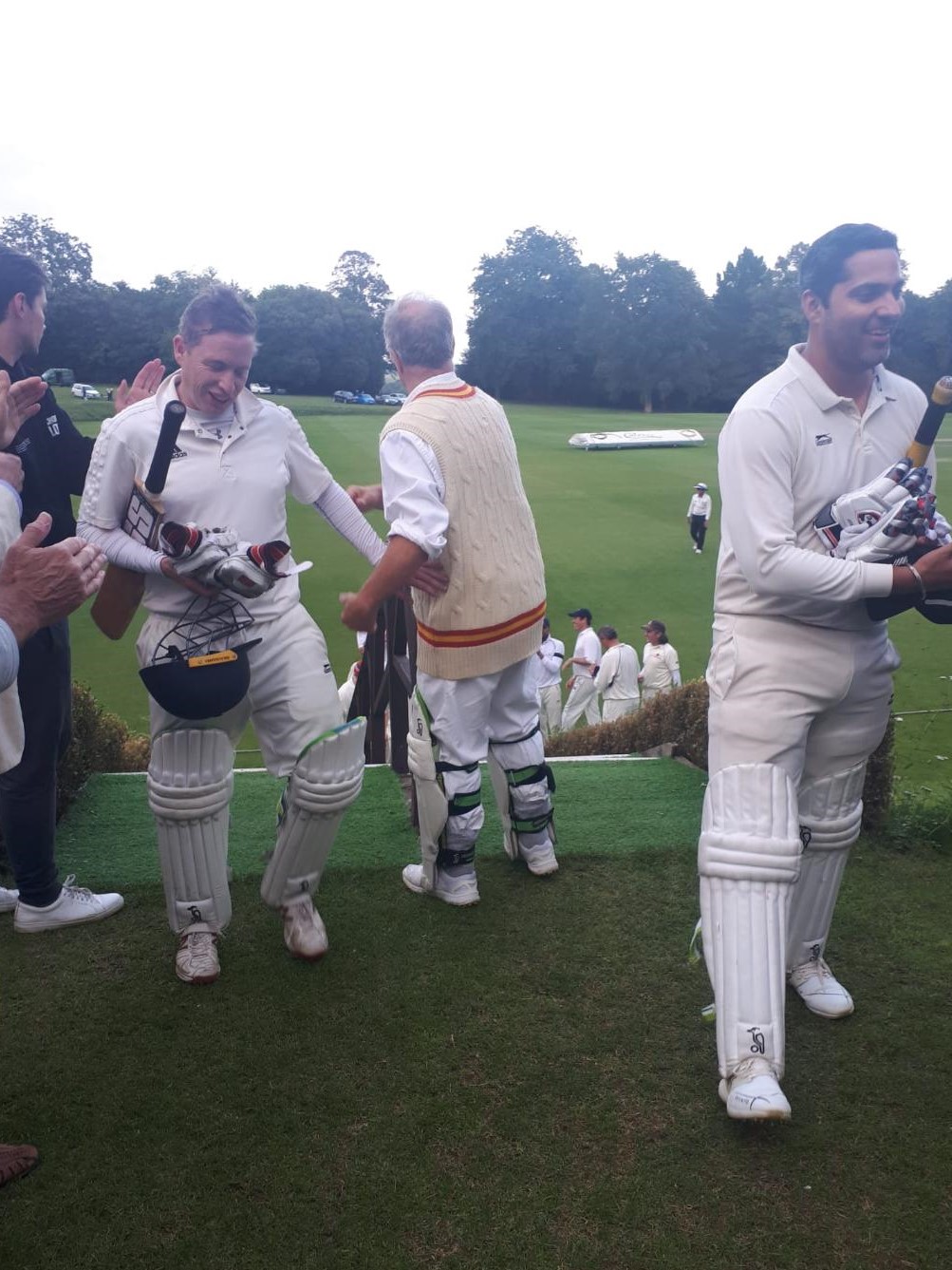A group of people in white uniforms
Description automatically generated